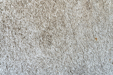 an old concrete wall. An empty background for a design or website. Reinforced concrete works. The weathered and dirty surface of the wall of an old uninhabited house