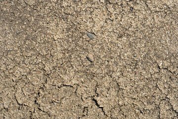 cracks on dry ground. Drought due to lack of precipitation. Poor harvest due to lack of moisture in the soil. An empty background and the texture of a weathered earth.
