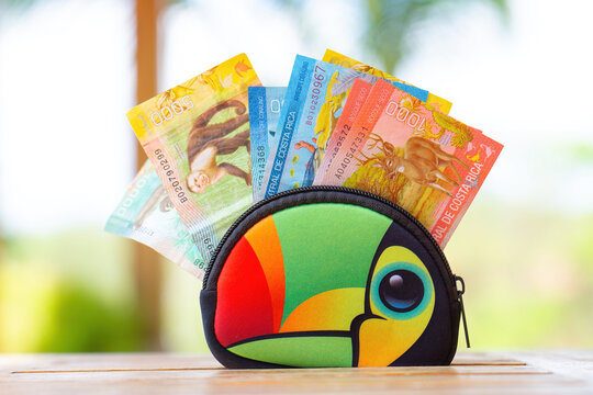 Costa Rican colones in a toucan zipper wallet