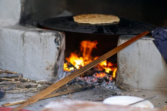 Traditional Turkish dish called "g&ouml;zleme", made of flatbread stuffed with meat or cheese and baked on sheet iron, being prepared for sale at a street food market. Pastry specialty in Turkey
