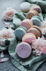 Beautiful colorful tasty macaroons on a concrete background