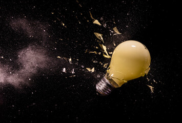 Fototapeta na wymiar yellow light bulb breaking