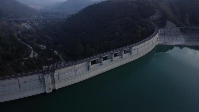 aerial footage - flying above an italian dam located in the village of Cingoli in winter