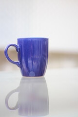 blue cup, cup of coffee on blue , reflection idea