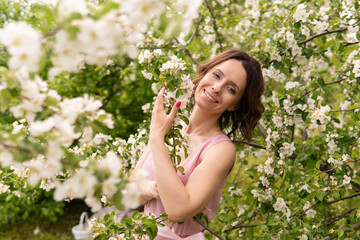 A woman near a blooming spring tree. Romantic happy mood.