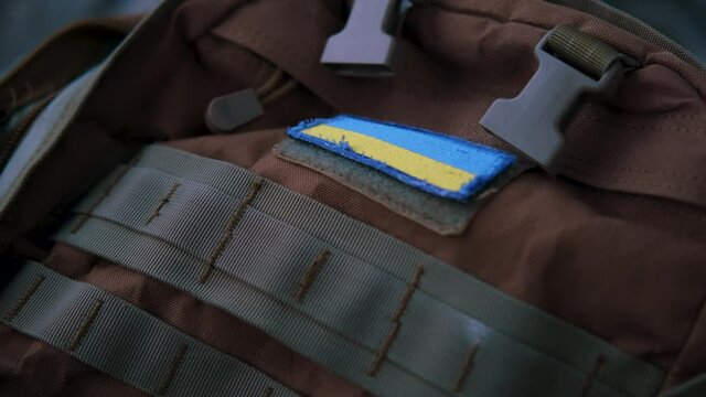 Close up shot of military backpack with Ukrainian flag