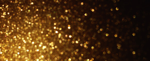 background of abstract gold and black glitter lights. defocused