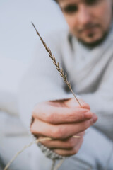 Delicate image of a young man touching nature