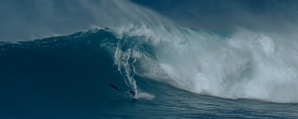 Sport photography. Jaws swell on International surfing event in Maui, Hawai 2021 December.