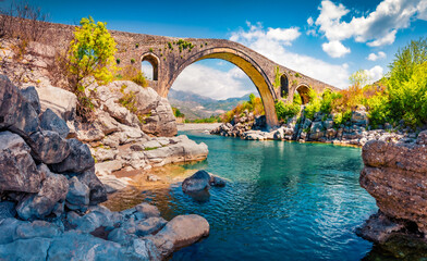 Stunning spring view of Old Mes Bridge. Gorgeous morning landscape of Shkoder. Colorful outdoor scene of Albania, Europe. Traveling concept background. - obrazy, fototapety, plakaty