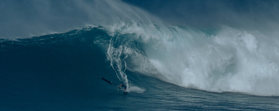 Sport photography. Jaws swell on International surfing event in Maui, Hawai 2021 December.