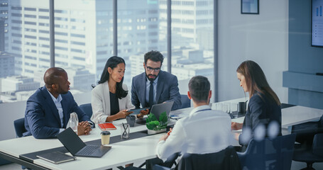 Modern Multi-Ethnic Office Conference Room Meeting: Diverse Team of Ambitious Top Managers, Executives Talk, Brainstorm, Use Tablet. Businesspeople Discuss Investment Strategy in e-Commerce Startup