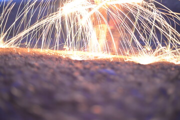 Iron wool circle drawing light fireworks. Burning Steel Wool spinning, Trajectories of burning sparks at night. Movement light effect, steel wool fire hoop. long exposure light painting, Pyrotechnic