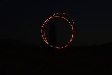 Iron wool circle drawing light fireworks. Burning Steel Wool spinning, Trajectories of burning sparks at night. Movement light effect, steel wool fire hoop. long exposure light painting, Pyrotechnic