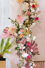 Decoration of the wedding hall with flowers in pink and white shades