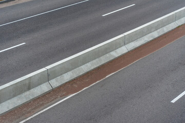 Road with markings and the separation barrier 