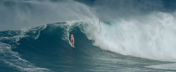 Sport photography. Jaws swell on International surfing event in Maui, Hawai 2021 December.
