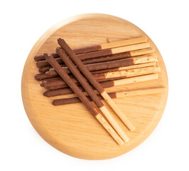 Chocolate stick biscuits in wooden plate isolated on white background, with clipping path,  ready to serve as snacks with tea and coffee on happy time. 