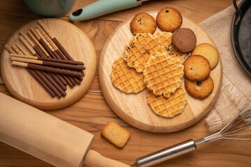 Homemade butter cookies and chocolate chip cookies and stick biscuits on wooden background ready to serve as snacks with tea and coffee on happy time.  