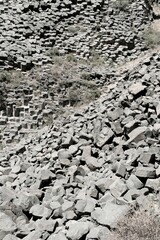 Stones of different shapes and sizes in the mountains of Armenia as a structural background.