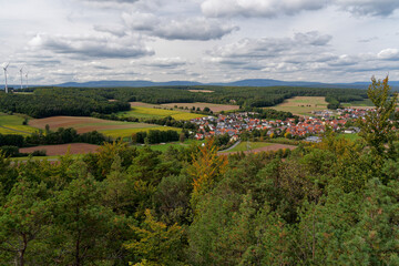 Fototapeta na wymiar Blick vom Michelsberg bei Münnerstadt auf Reichenbach im Biosphärenreservat Rhön, Unterfranken, Bayern, Deutschland