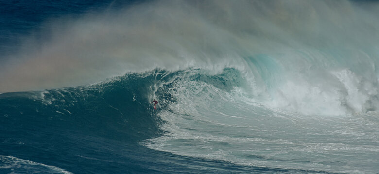 Sport photography. Jaws swell on International surfing event in Maui, Hawai 2021 December.