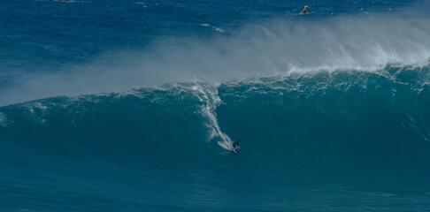 Sport photography. Jaws swell on International surfing event in Maui, Hawai 2021 December.