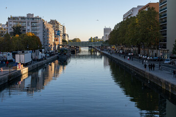 Fototapeta premium Paris, France - 10 24 2021: View of the Ourcq canal from the lift bridge at sunrise