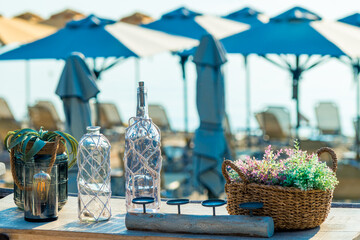 Decorated bottles and flowers on the table in the street