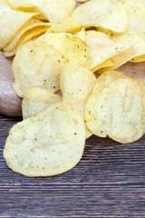 thin potato chips with spices and salt
