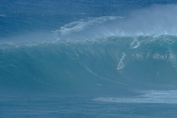 Sport photography. Jaws swell on International surfing event in Maui, Hawai 2021 December.