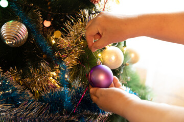 Soon Christmas and New Year, decorating the tree with toys
