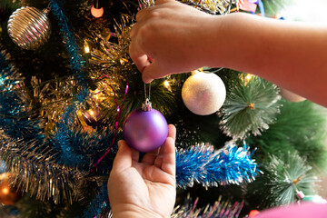 Soon Christmas and New Year, decorating the tree with toys