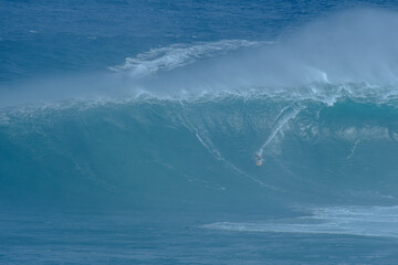 Sport photography. Jaws swell on International surfing event in Maui, Hawai 2021 December.