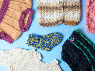 Knitted warm baby clothes. Multicolored socks, hats and gloves for girls and boys.