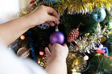 Soon Christmas and New Year, decorating the tree with toys