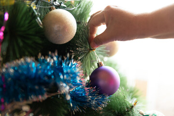 Soon Christmas and New Year, decorating the tree with toys