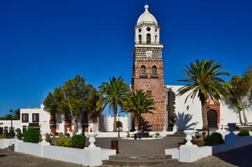 Fototapeta na wymiar The church Parroquia de Nuestra Senora de Guadalupe de Teguise in the town Tahiche, Lanzarote, Spain. In front the Plaza de la constitucion.