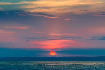 Evening sky with dramatic clouds over the sea. Dramatic sunset over the sea.