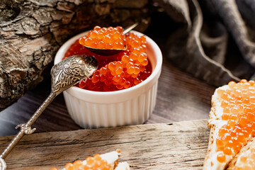 red caviar on wooden background - obrazy, fototapety, plakaty