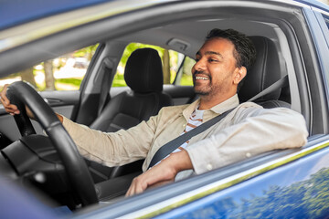 Fototapeta na wymiar transport, vehicle and people concept - happy smiling indian man or driver driving car