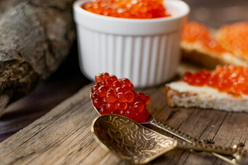 red caviar on a wooden spoon
