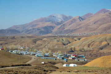 Small town in the middle of the desert with mountains and snow