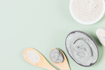 Cosmetic clay face mask mixed with water next to dry powder