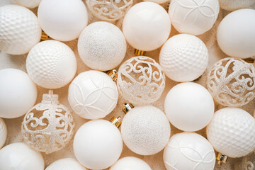 Christmas background of white colored Christmas balls. Flat lay on the theme of the New Year holiday.