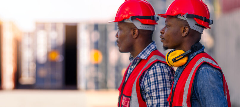Engineer or two African workers in a container yard
