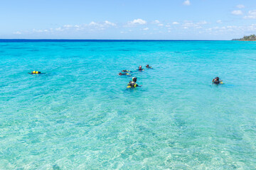 Fototapeta na wymiar DIvers in beautiful blue water, Playa Giron, Cuba