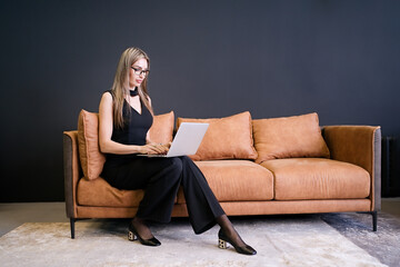 Businesswoman working on laptop in her workstation in modern office                              