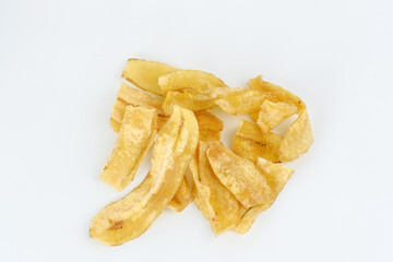 Heap of dried banana chips snack on white background. Selective focus image, blurred background.

