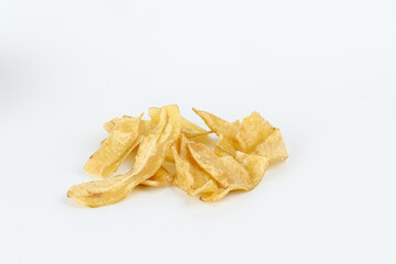 Heap of dried banana chips snack on white background. Selective focus image, blurred background.

